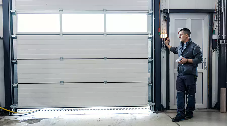 Garage door service provider inspecting a residential door